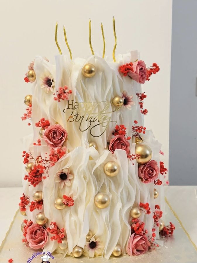 White ruffle cake with pink roses and gold